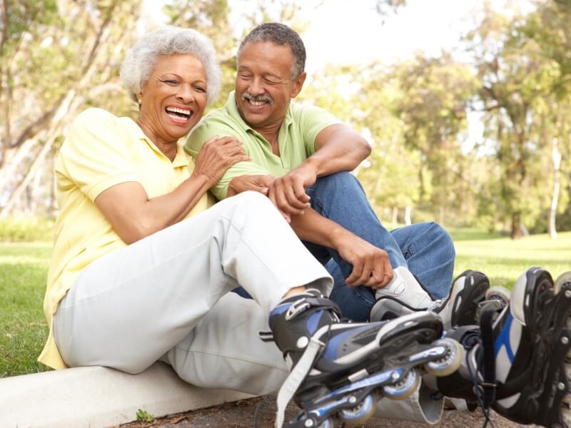 Happy Laughing Rollerblading Couple Outdoors