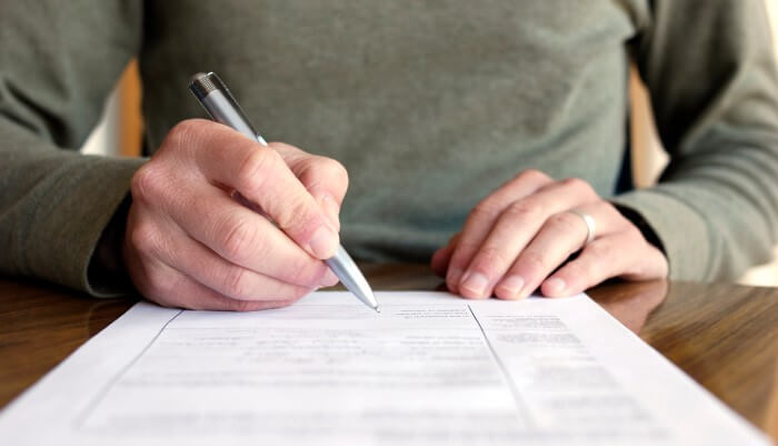 Image of a medical management specialist taking notes for a Primary Care Physician near northern Alabama. Patient Documents.